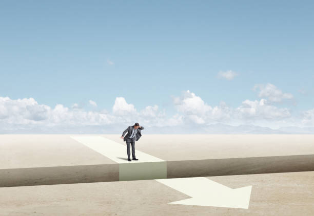 istock Man Stands At Edge Of  Gap Interupting An Arrow 2201935601