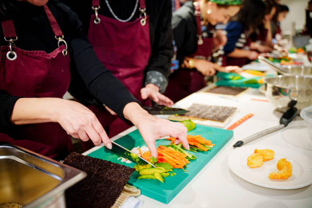 istock A group of diverse individuals wearing aprons carefully prepares sushi rolls during a hands-on cooking class 2201937274
