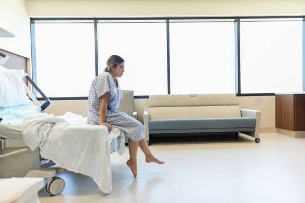 istock Young Woman Sitting on Hospital Bed, Contemplative 2201938572