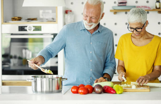 istock Mature couple cooking lunch together. 2201938833