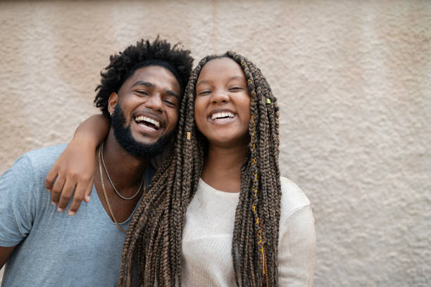 istock Portrait of afro friends hugging on a beige background 2201939093