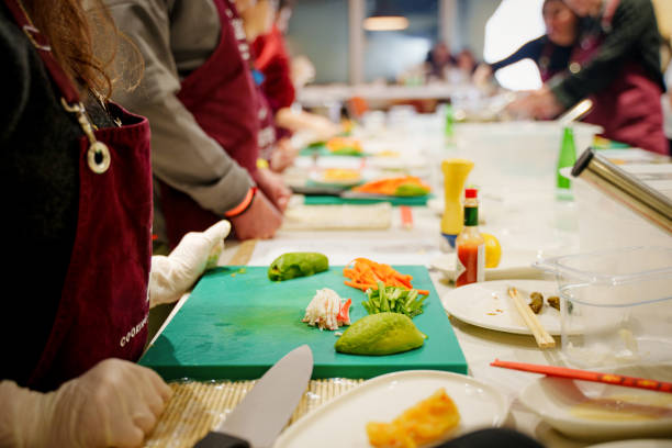 istock A group of diverse individuals wearing aprons carefully prepares sushi rolls during a hands-on cooking class 2201939491