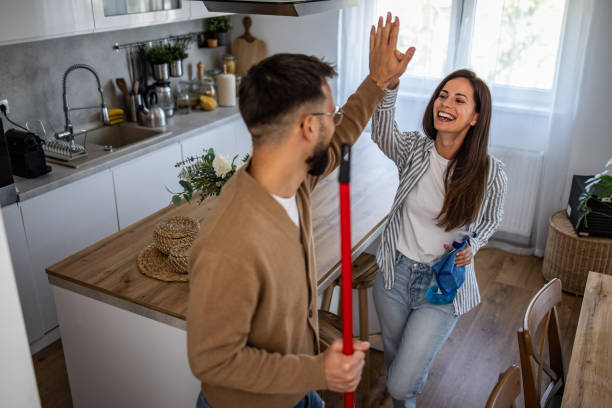 istock Happy couple cleaning their home and giving each other a high five 2201939532