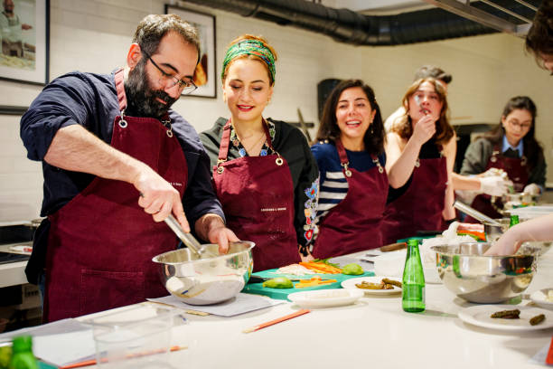 istock A group of diverse individuals wearing aprons carefully prepares sushi rolls during a hands-on cooking class 2201939647