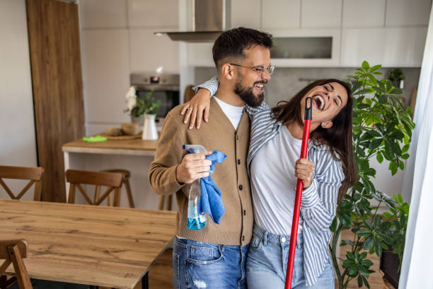 istock Happy couple cleaning home together and having fun 2201939654