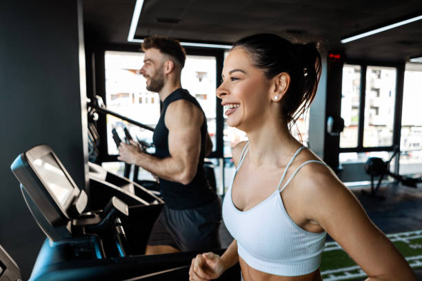 istock Male and Female Runners Powering Through a Treadmill Workout 2201942219