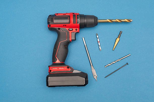 istock cordless screwdriver with drills on a blue background. 2201944365