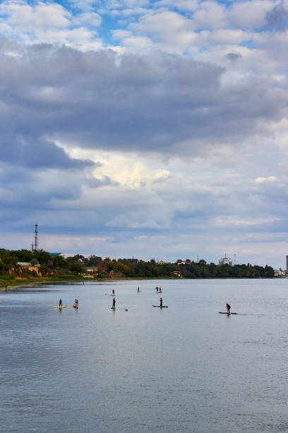 istock Group of young people Paddleboarding (SUP paddle). Stand up paddle, in Danube river at sunset 2201947186