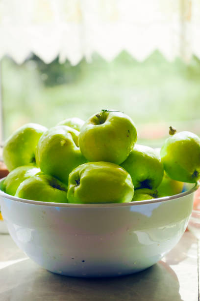 istock A bowl of green apples sits on a counter with a rustic look 2201948654