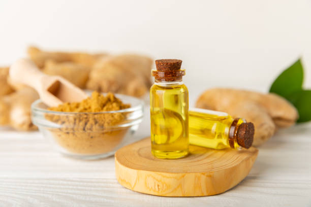 istock Ginger essential oil on texture background. Fresh ginger slices. Essence, serum, oil. Alternative medicine. Phytotherapy. Health and beauty concept. Place for text. Copy space. 2201949832