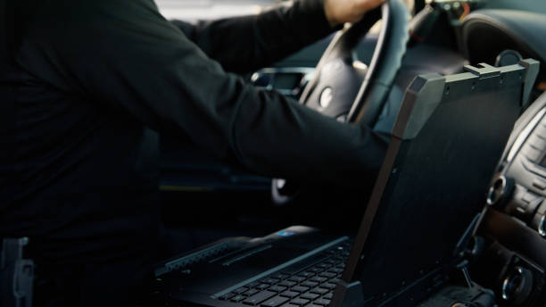 istock Police Officer Driving  Patrol Car 2201950010