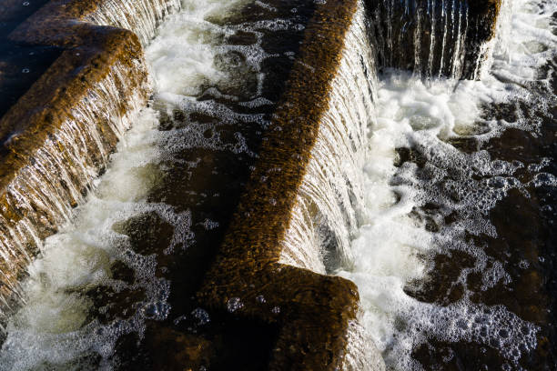 istock The waterfall is nearby. Falling water in a waterfall. Foam from the waterfall 2201950226