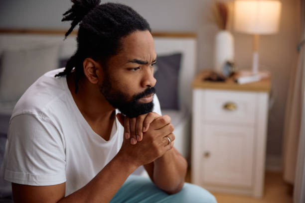 istock Thoughtful black man in bedroom at home. 2201952086