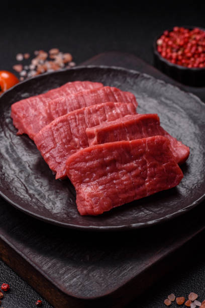 istock Raw beef tenderloin cut into slices with salt and spices 2201952126