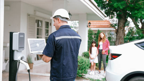 istock Qualified technician working with laptop for home EV station. Synchronos 2201952809