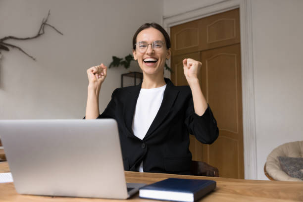 istock Woman making celebratory gesture, received message with good news 2201952965