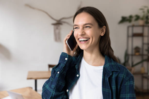 istock Young woman talking on smartphone at workplace 2201954101