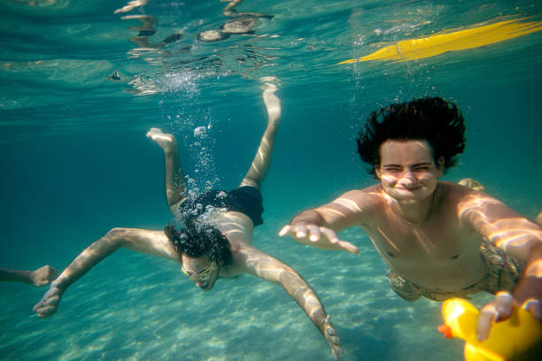 istock Friends diving into the ocean 2201956081