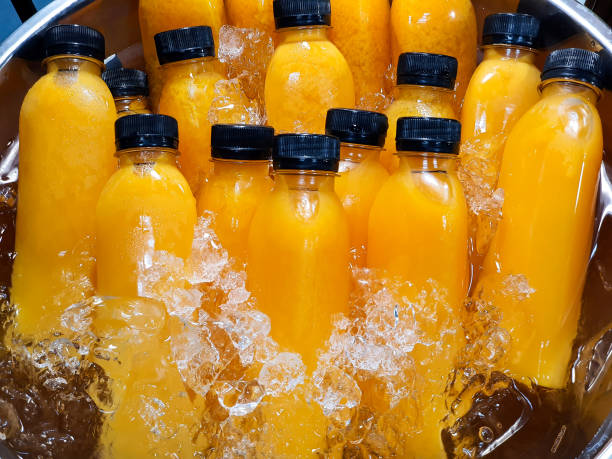 istock Orange juice in plastic bottles, black screw caps. 2201956449