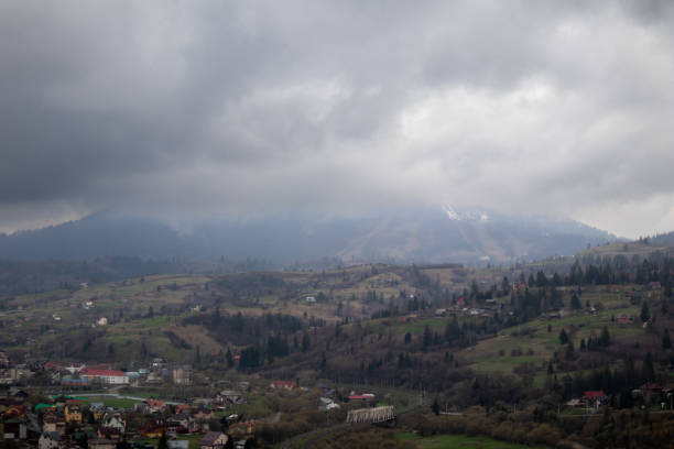 istock Carpathian Spring: Verdant Hills, Fog and Majestic Clouds 2201957711