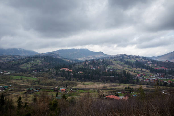 istock Carpathian Spring: Verdant Hills, Fog and Majestic Clouds 2201957712
