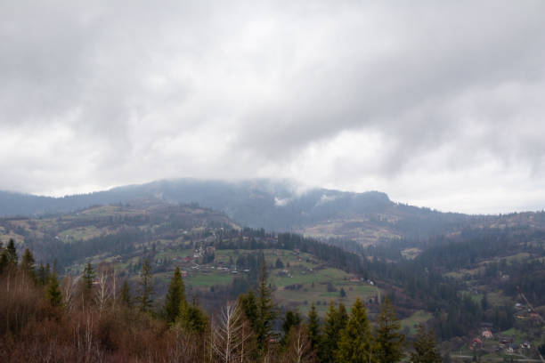 istock Carpathian Spring: Verdant Hills, Fog and Majestic Clouds 2201959238