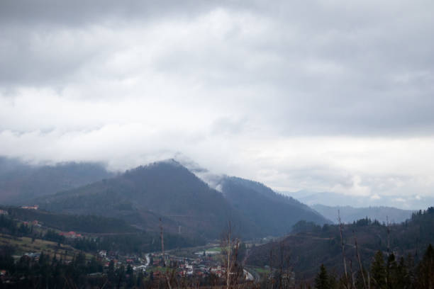 istock Carpathian Spring: Verdant Hills, Fog and Majestic Clouds 2201959241