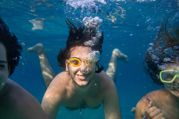 istock Friends diving into the ocean making air bubbles 2201961259
