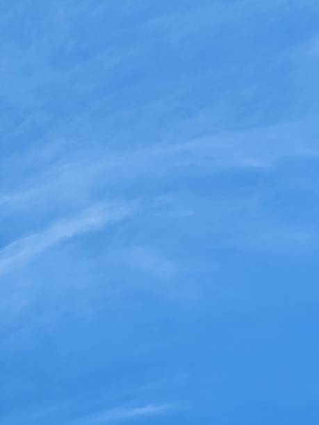 On a sunny day, the bright blue sky is dotted with scattered white clouds. The interaction between sunlight and clouds creates a visual symphony of light and shadow, mesmerizing those who observe and celebrating natural beauty.