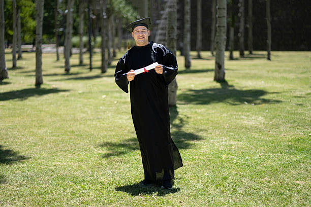 istock Happy male student with diploma at graduation. 2201965933