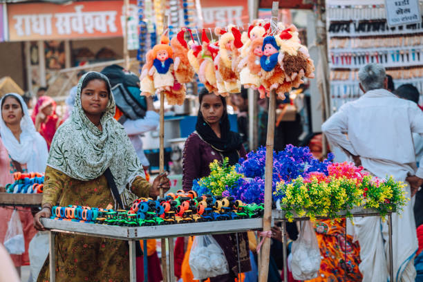 Cheerful pretty women of Indian ethnicity purchasing jewelry in store portrait close up.