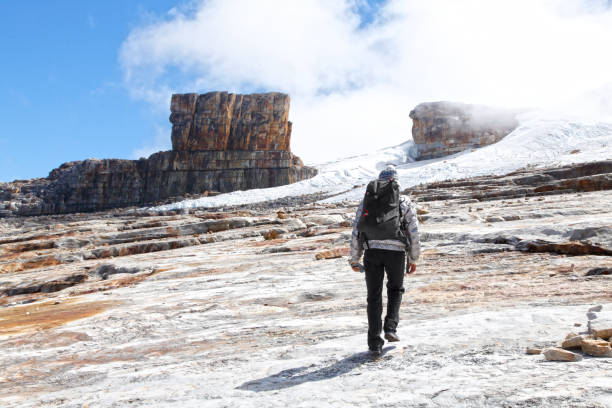 istock Young woman climbing snow mountain 2201971351