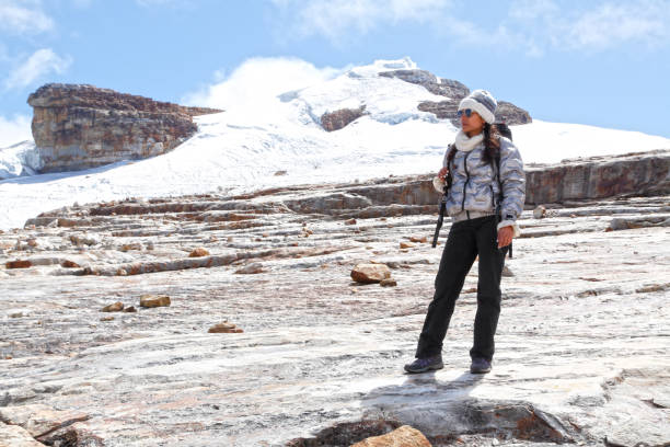 istock Young woman climbing snow mountain 2201971364