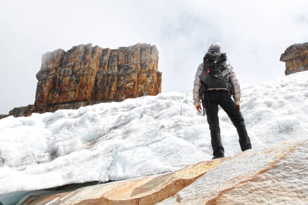 istock Young woman climbing snow mountain 2201971380