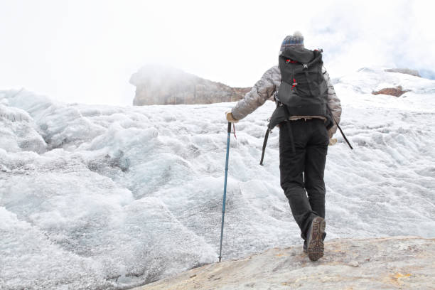 Young woman climbing snow mountain