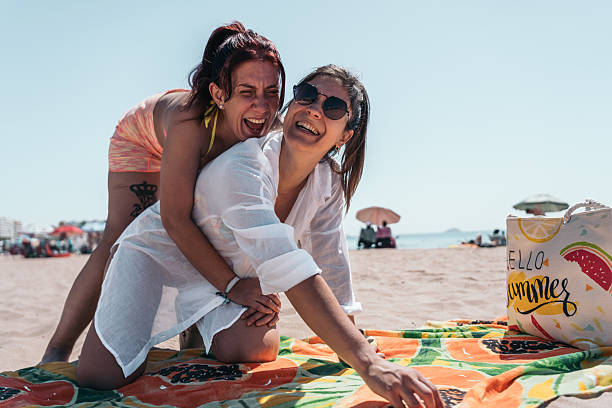 istock Two women having fun on the beach on summer vacation 2201972819