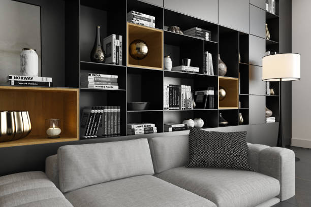 A beautifully designed modern interior living room featuring a spacious layout with a large portal window leading to a patio. The room showcases a cozy yet luxurious aesthetic with black-and-white tones, a light grey fabric sofa, and stylish seating arrangements. A wall of shelves adorned with books and household decorations adds sophistication, while a large carpet and coffee table complete the elegant ambiance. Ideal for renovation projects, architecture firms, real estate listings, designer portfolios, rentals, and interior design inspiration.