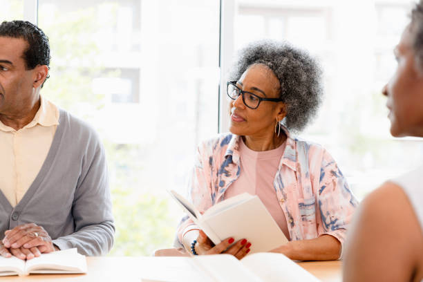 istock Mature Adults in Book Club Discussion, Group Therapy Session 2201973553