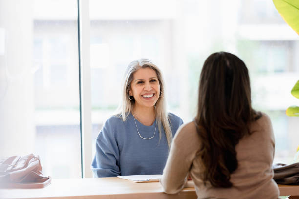 istock Smiling Woman Listening Attentively During a Counseling Session 2201973577