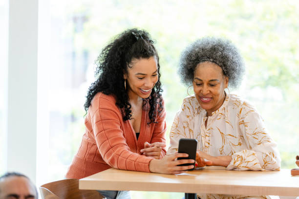istock Happy Multiracial Women Using Smart Phone Together 2201973584