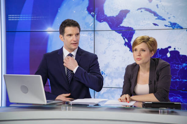 istock Journalists in a tv news studio 2201973873