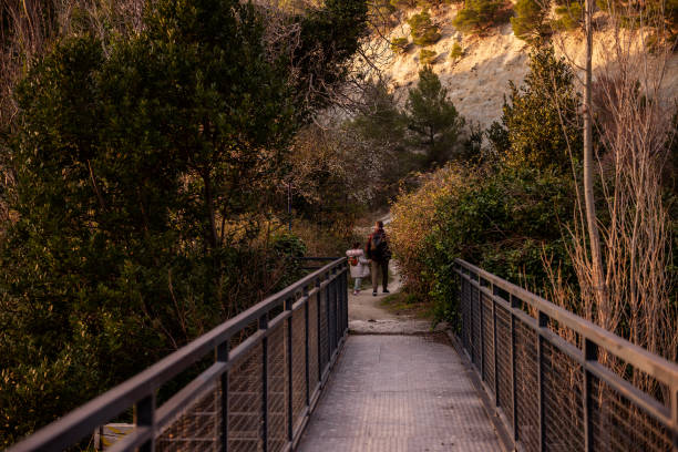 istock Father and Daughter Hiking on a Nature Trail 2201975098