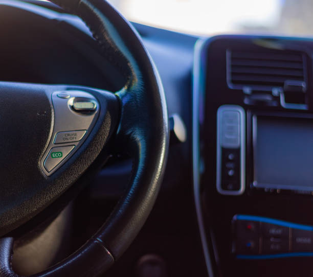 steering wheel and speedometer in the cockpit of a simple car, machine control panel. High quality photo