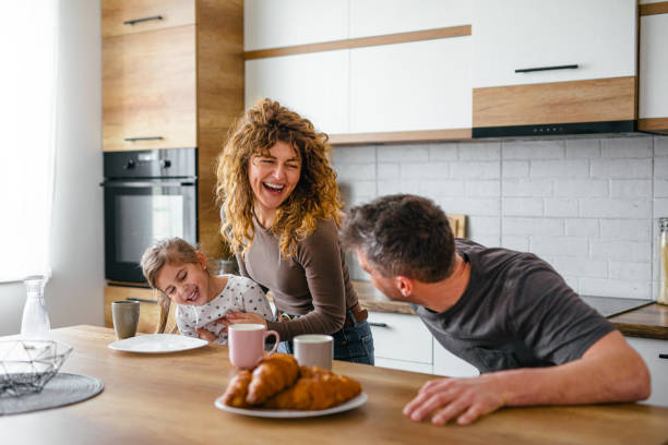 istock Happy family having breakfast in the kitchen in the morning 2201978162