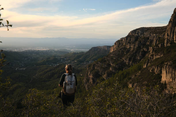 istock A woman from the back descending from the mountain 2201978655