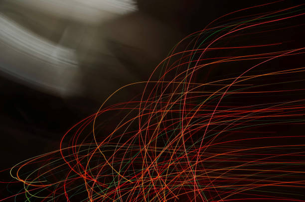 Vibrant multicolored light trails form abstract swirls in a dynamic, eye-catching composition