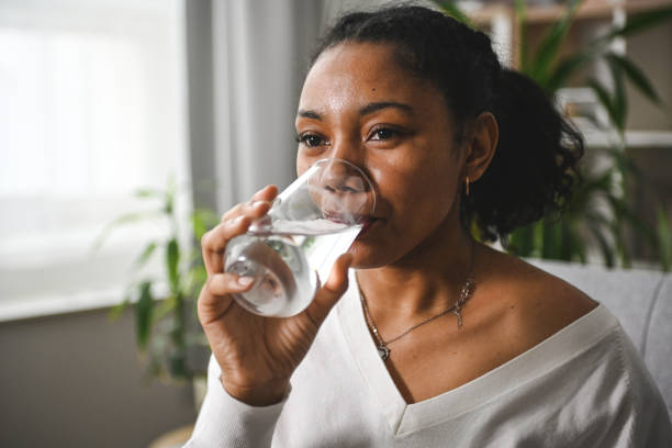 istock woman drinking water from a glass 2201980870