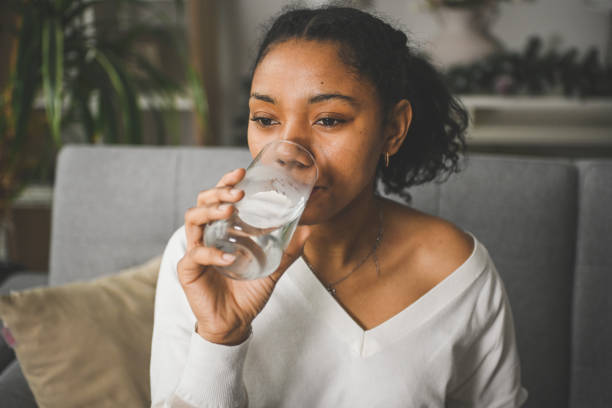 istock woman drinking water from a glass 2201981887