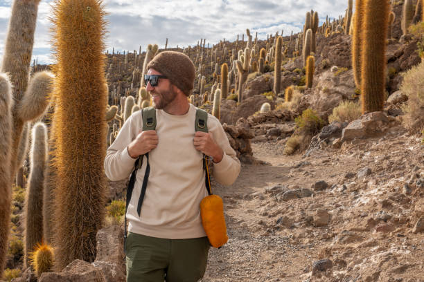 istock Man Hiking Through Desert Trail with Cacti 2201983135
