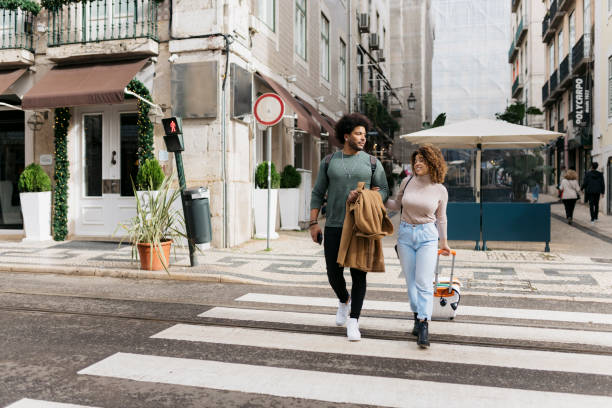 istock Tourists couple walking on crosswalk exploring city on vacation 2201987912